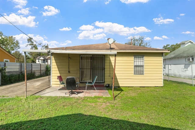 rear view of property with a patio area and a yard