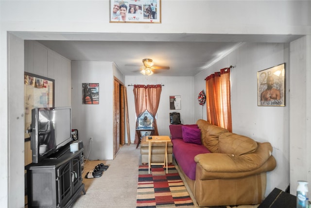 living room with ceiling fan and carpet