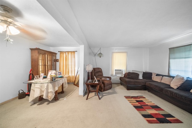 carpeted living room with ceiling fan