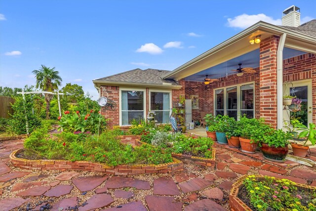 exterior space with ceiling fan and a patio area