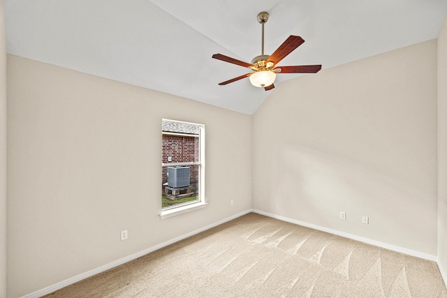 carpeted empty room featuring ceiling fan and vaulted ceiling