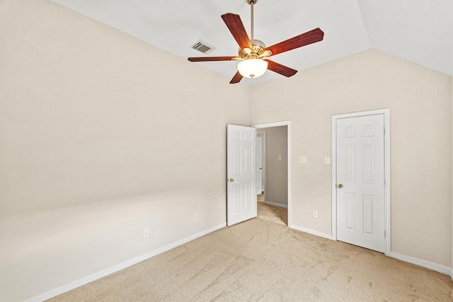 unfurnished bedroom featuring ceiling fan, lofted ceiling, and carpet floors