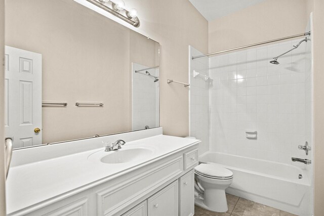 full bathroom with tile patterned floors, vanity, toilet, and tiled shower / bath