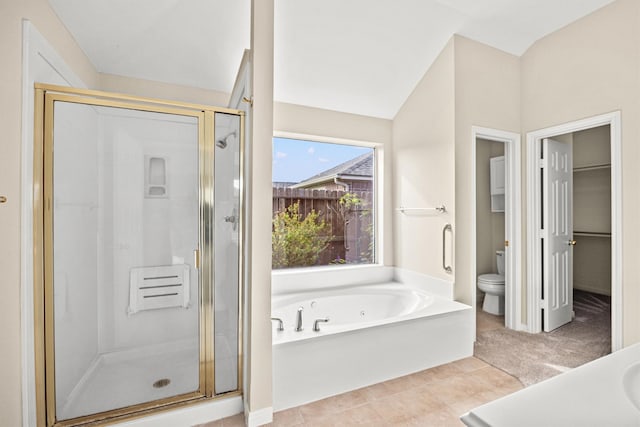 bathroom with tile patterned flooring, independent shower and bath, and toilet