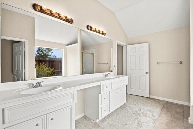 bathroom with vanity, tile patterned floors, a shower with door, and lofted ceiling