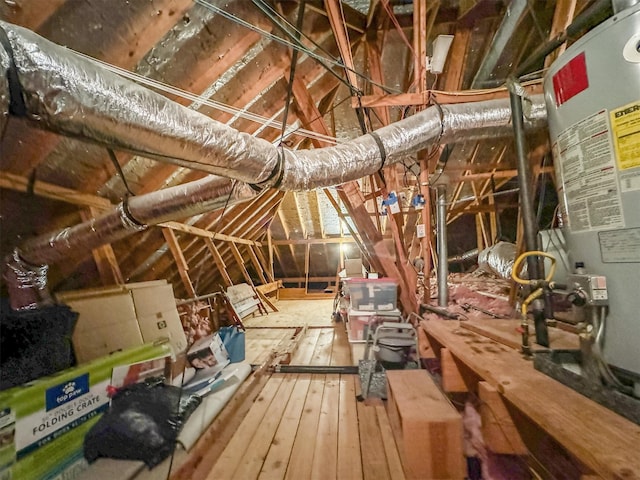 unfinished attic featuring water heater