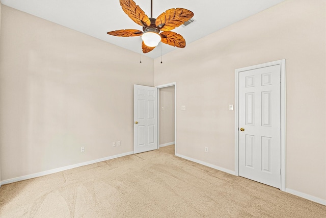 carpeted empty room featuring ceiling fan