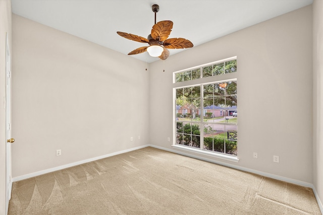 carpeted spare room with ceiling fan