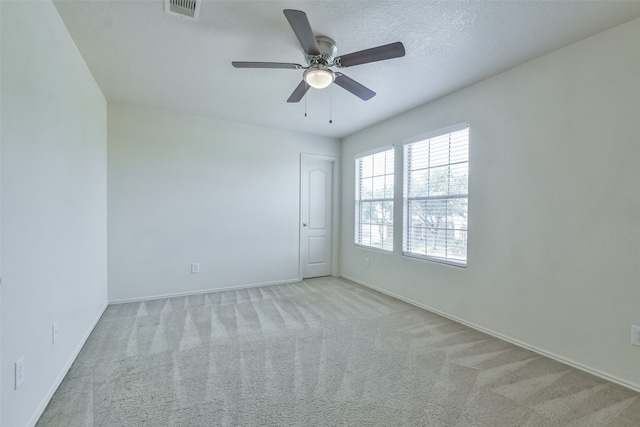 empty room featuring light carpet and ceiling fan