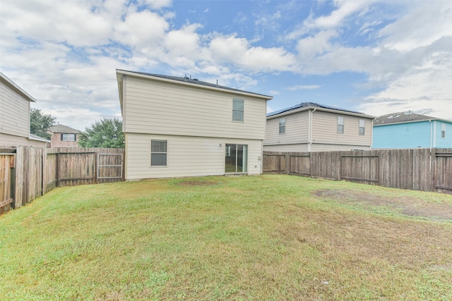 rear view of house with a yard