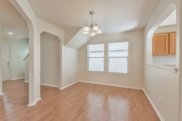 unfurnished dining area featuring light wood-type flooring and a chandelier