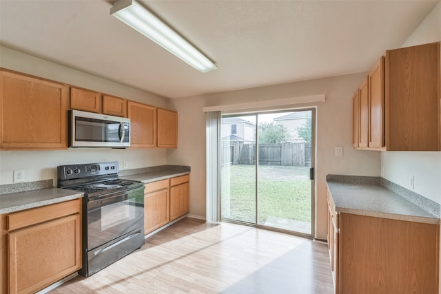 kitchen featuring light wood-type flooring and electric range