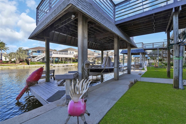 dock area with a water view and a yard