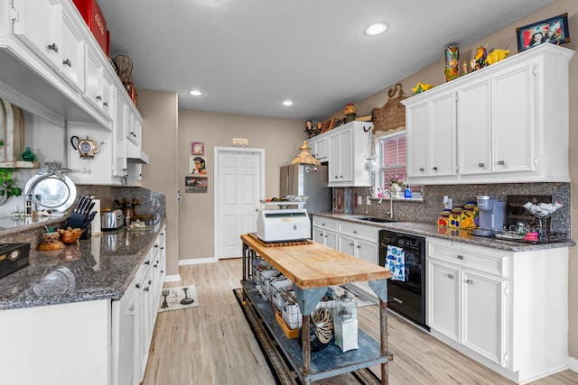 kitchen featuring white cabinets, light hardwood / wood-style floors, sink, and dishwasher