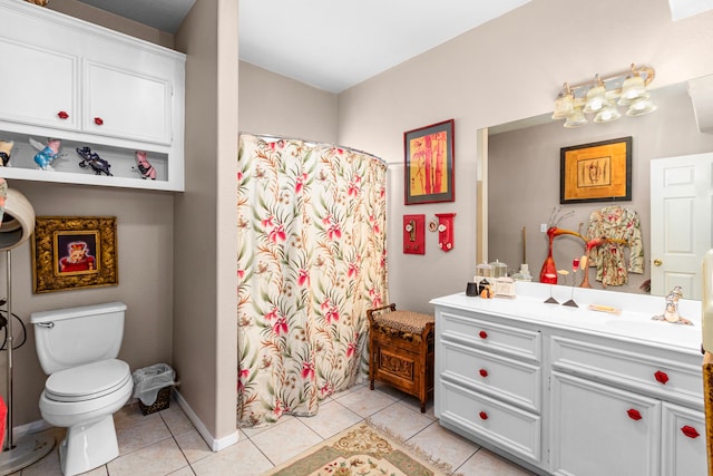 bathroom featuring toilet, vanity, and tile patterned flooring