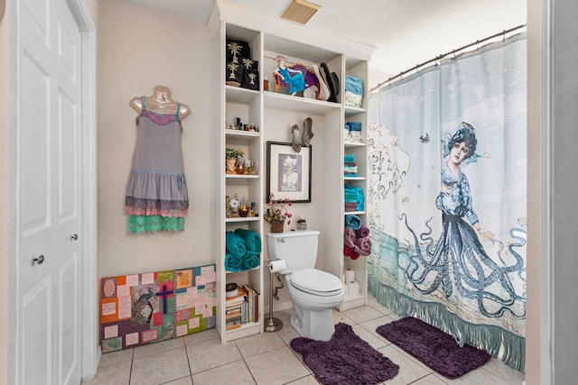 bathroom featuring walk in shower, tile patterned flooring, a textured ceiling, and toilet