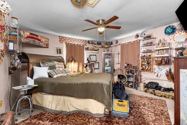 carpeted bedroom featuring ceiling fan and a textured ceiling