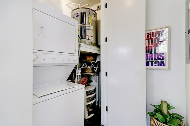 washroom featuring stacked washing maching and dryer, water heater, and laundry area