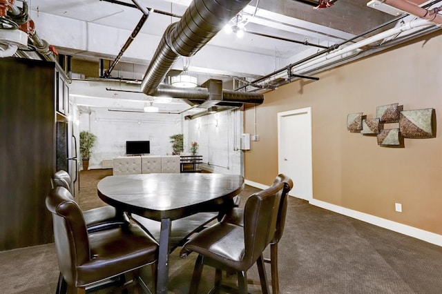 dining room featuring baseboards and dark carpet