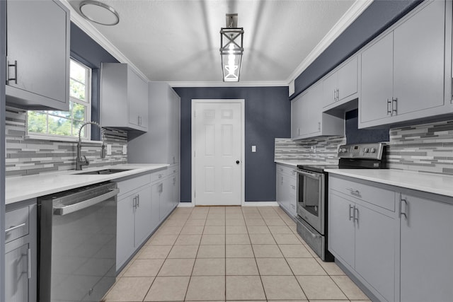 kitchen with decorative light fixtures, sink, crown molding, and stainless steel appliances