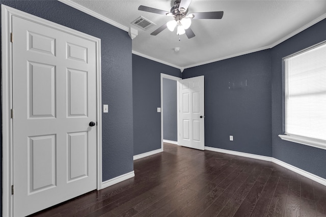 unfurnished bedroom featuring crown molding, dark hardwood / wood-style floors, and ceiling fan