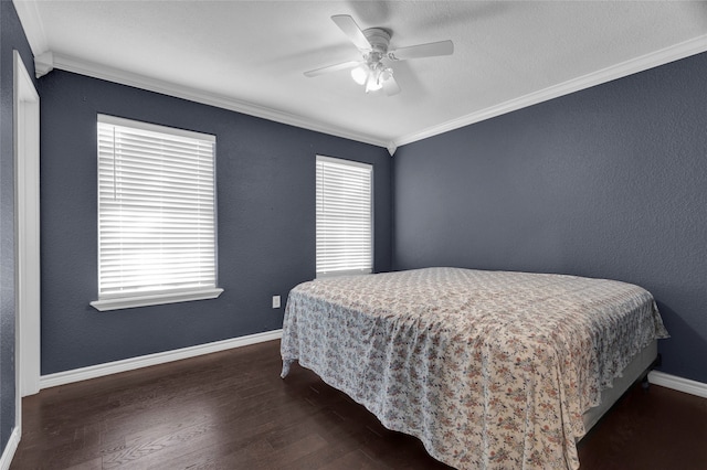 bedroom with dark wood-type flooring, ceiling fan, and crown molding