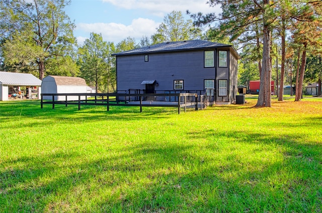 view of yard with cooling unit and an outbuilding