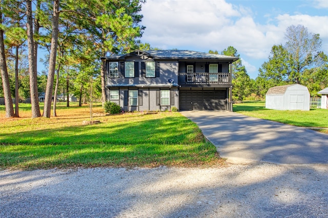 view of front of home with a garage, a front yard, and a shed