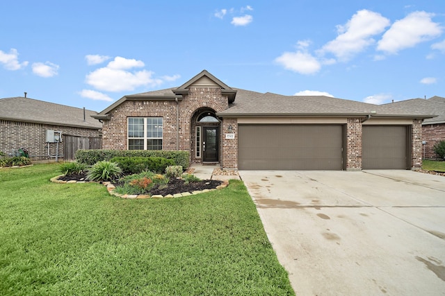 view of front of property with a garage and a front lawn