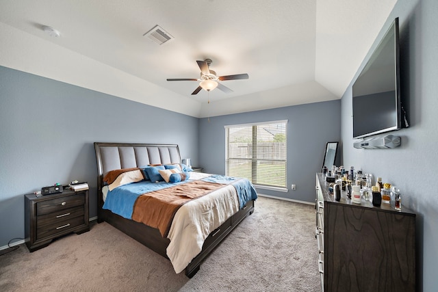 bedroom with ceiling fan, light carpet, and vaulted ceiling