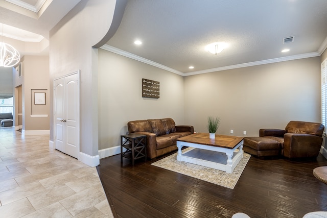 living room with ornamental molding and hardwood / wood-style flooring