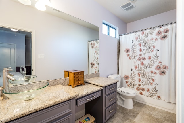 full bathroom featuring shower / bath combo, vanity, and toilet