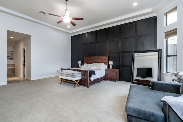 bedroom with light colored carpet, ensuite bath, ceiling fan, and crown molding