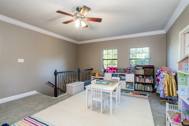 recreation room featuring light carpet, crown molding, ceiling fan, and a textured ceiling