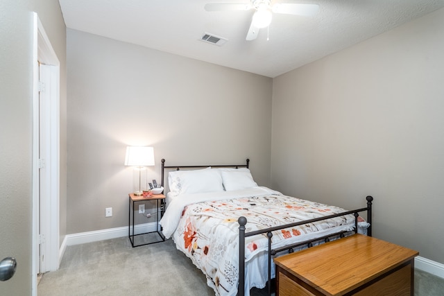 bedroom featuring light carpet and ceiling fan