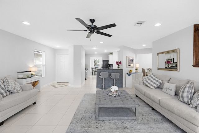 living room with light tile patterned floors and ceiling fan