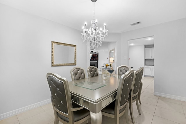 tiled dining area with a notable chandelier