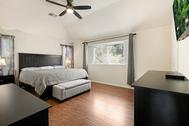 bedroom featuring dark wood-type flooring, ceiling fan, and vaulted ceiling