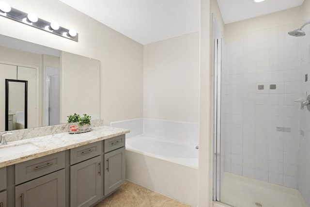 bathroom featuring tile patterned flooring, vanity, and plus walk in shower