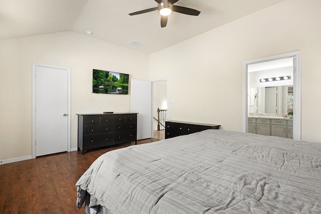 bedroom featuring ensuite bathroom, dark hardwood / wood-style flooring, ceiling fan, and vaulted ceiling