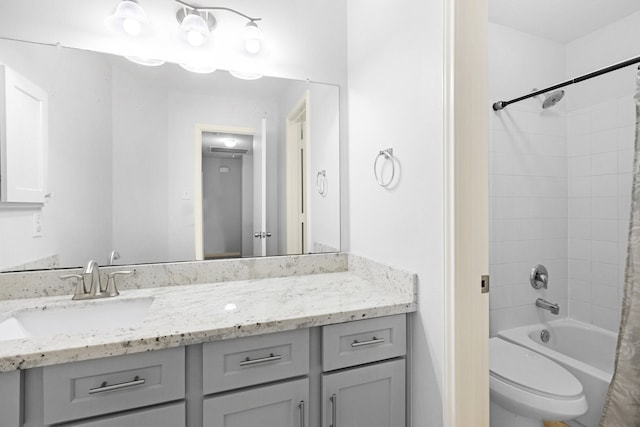 full bathroom with shower / bath combo, vanity, and toilet