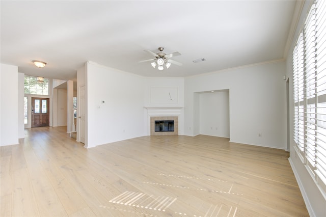 unfurnished living room featuring a fireplace, ceiling fan, crown molding, and light hardwood / wood-style flooring