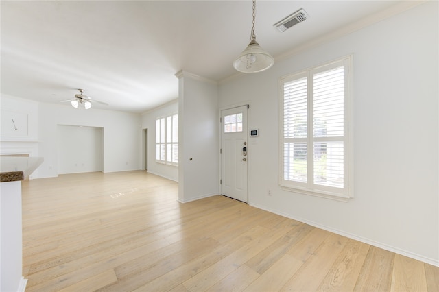 foyer entrance featuring ceiling fan, crown molding, and light hardwood / wood-style flooring