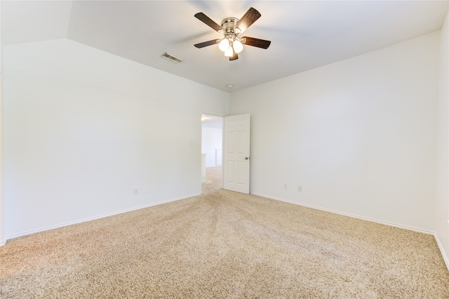 empty room featuring ceiling fan, carpet flooring, and lofted ceiling