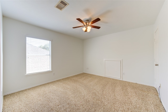 empty room with ceiling fan and light carpet