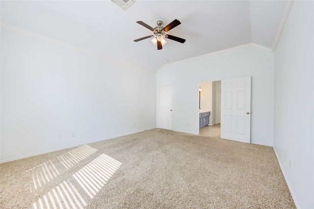 carpeted empty room featuring ornamental molding, ceiling fan, and vaulted ceiling