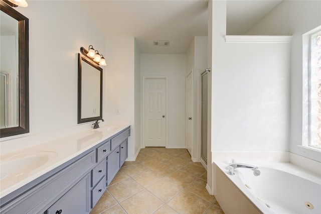 bathroom featuring plus walk in shower, vanity, and tile patterned flooring