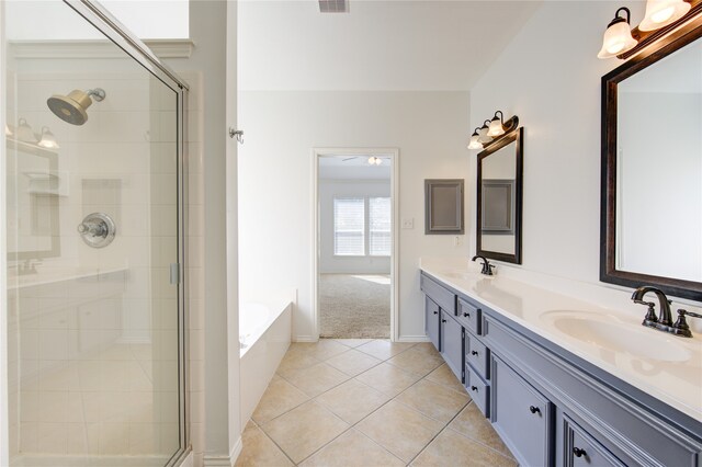 bathroom with vanity, tile patterned floors, and plus walk in shower