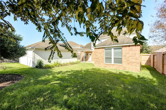 rear view of house featuring a lawn