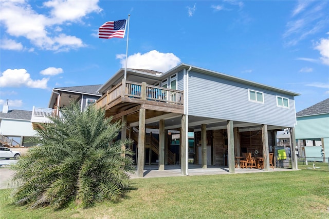 back of house featuring a yard, a deck, and a patio